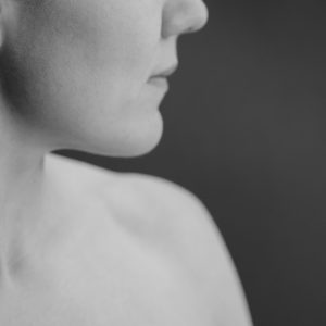 woman-neck-and-chin-close-up-on-brown-2021-09-01-09-38-11-utc-min